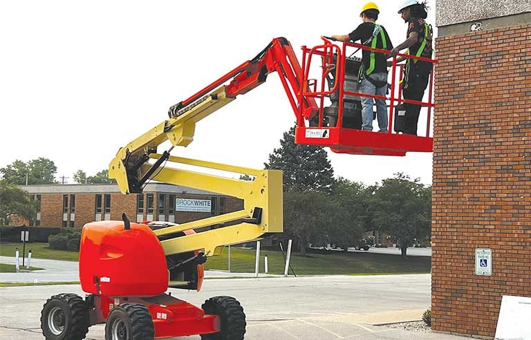 Image reference for blog post showing two workers in a boom lift with appropriate safety equipment.