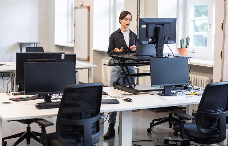 A woman standing in front of the desk