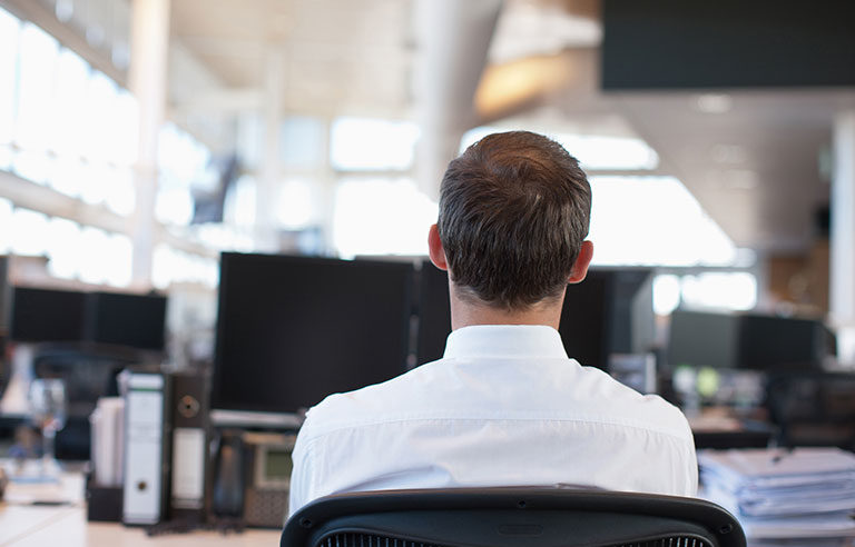 A man in front of a desk