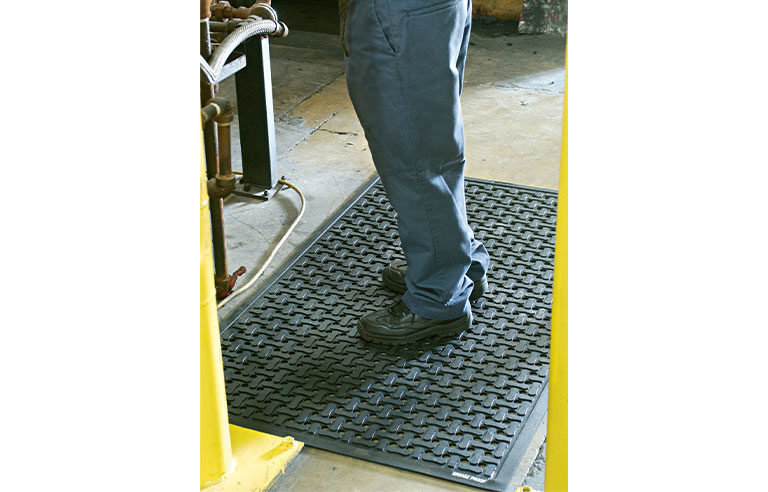 Man standing on an industrial mat