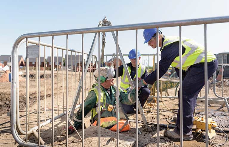 Construction workers working in confined spaces