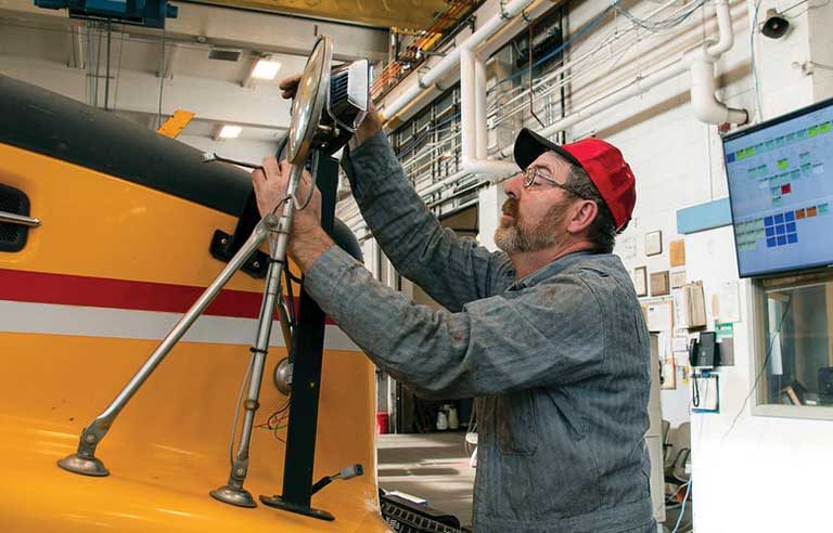 A mechanic working on a bus.