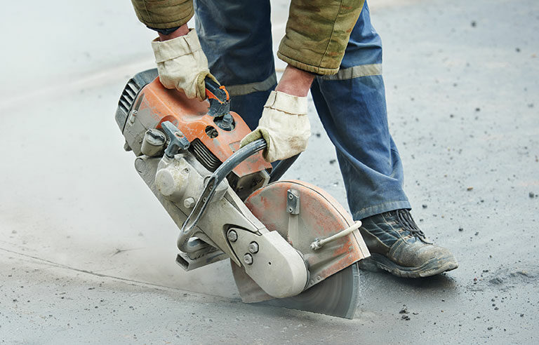 A worker working with a saw blade.