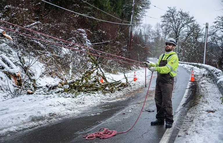 A worker working in the snow.