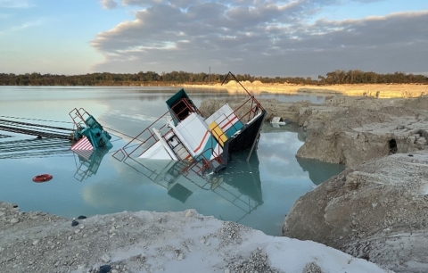 A dragline excavator slid into a water-filled pit.
